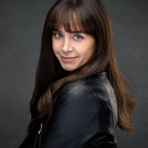 Commercial-style acting headshot of a woman in a black leather jacket, professional Cheshire studio session