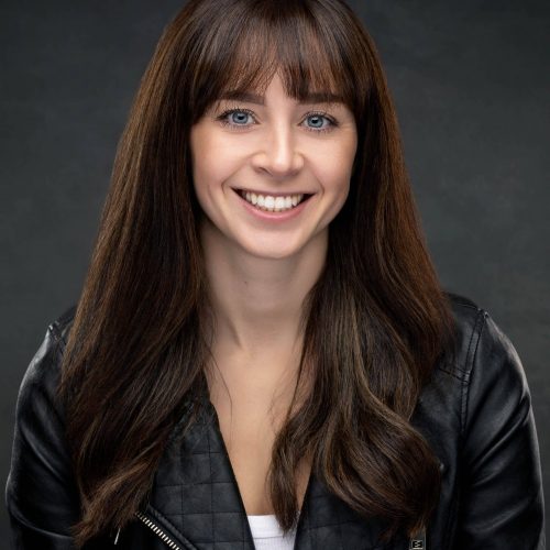 Friendly and approachable theatrical headshot of a female performer, captured by Paul's Portraits