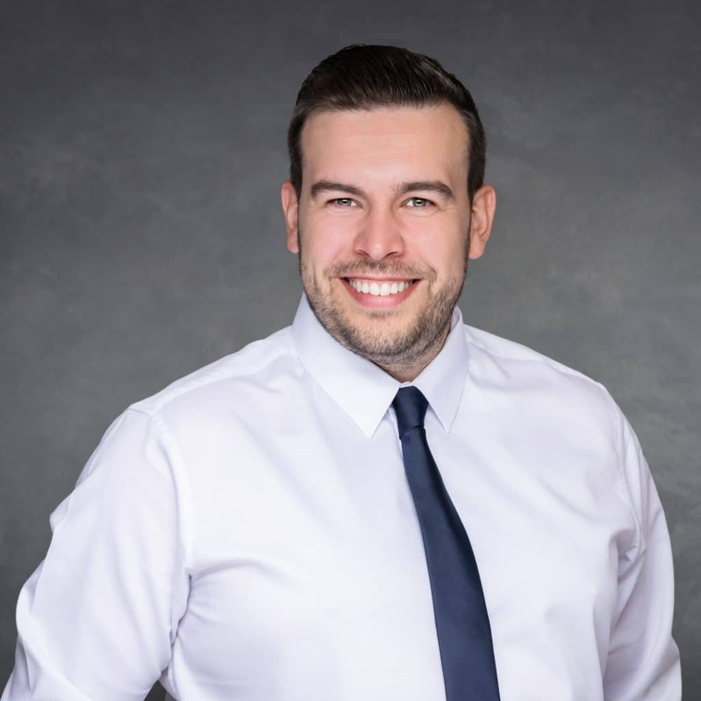 Dark background corporate portrait of a Northwich lawyer, demonstrating Paul's Portraits studio lighting expertise.