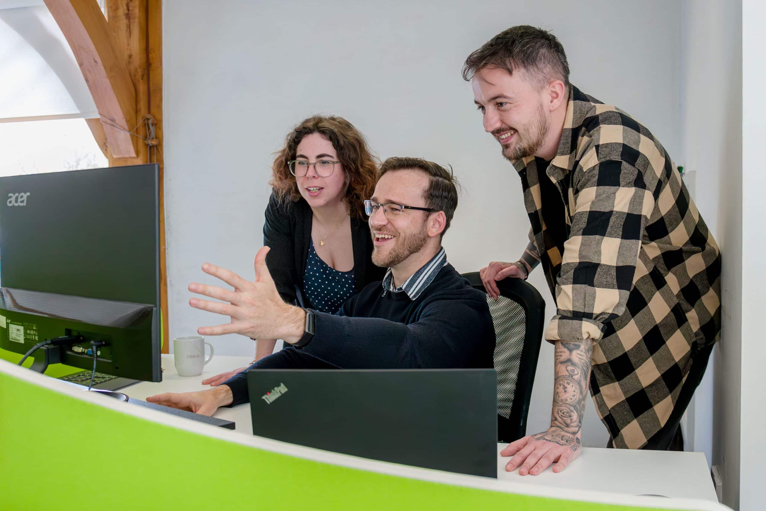 Three Nexus Point employees reviewing data at their head office
